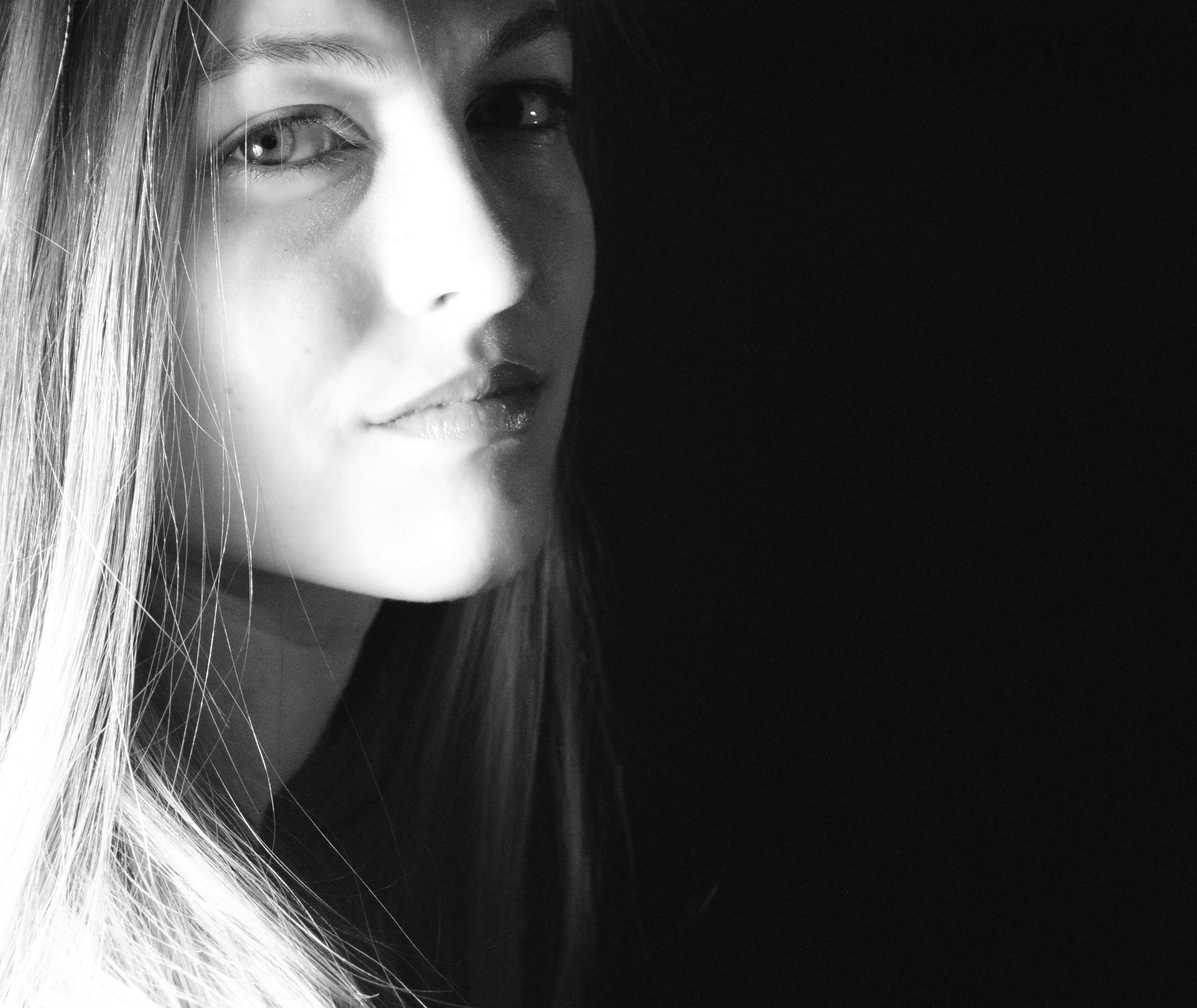 Black and white portrait of a girl who appears mildly anxious or tense