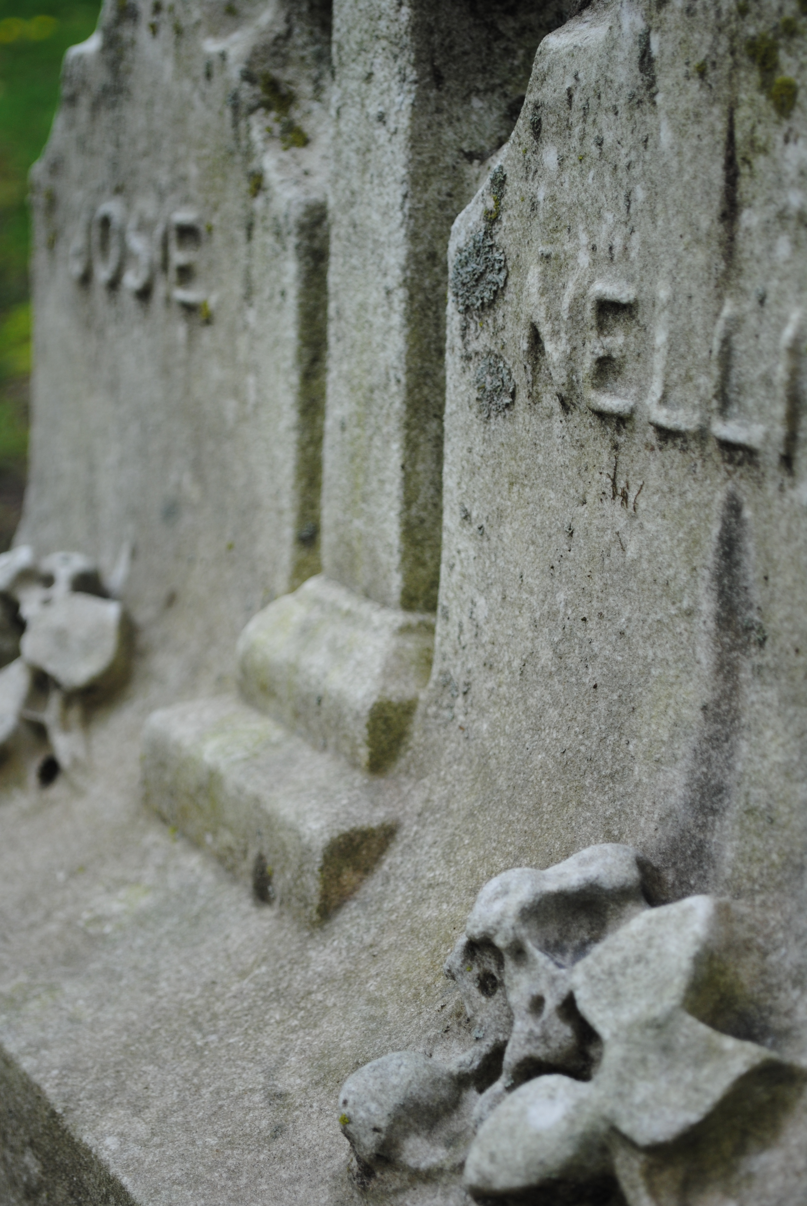 Color photo of a close up of two old gravestones with the names "Rosie" and Nellie" on them